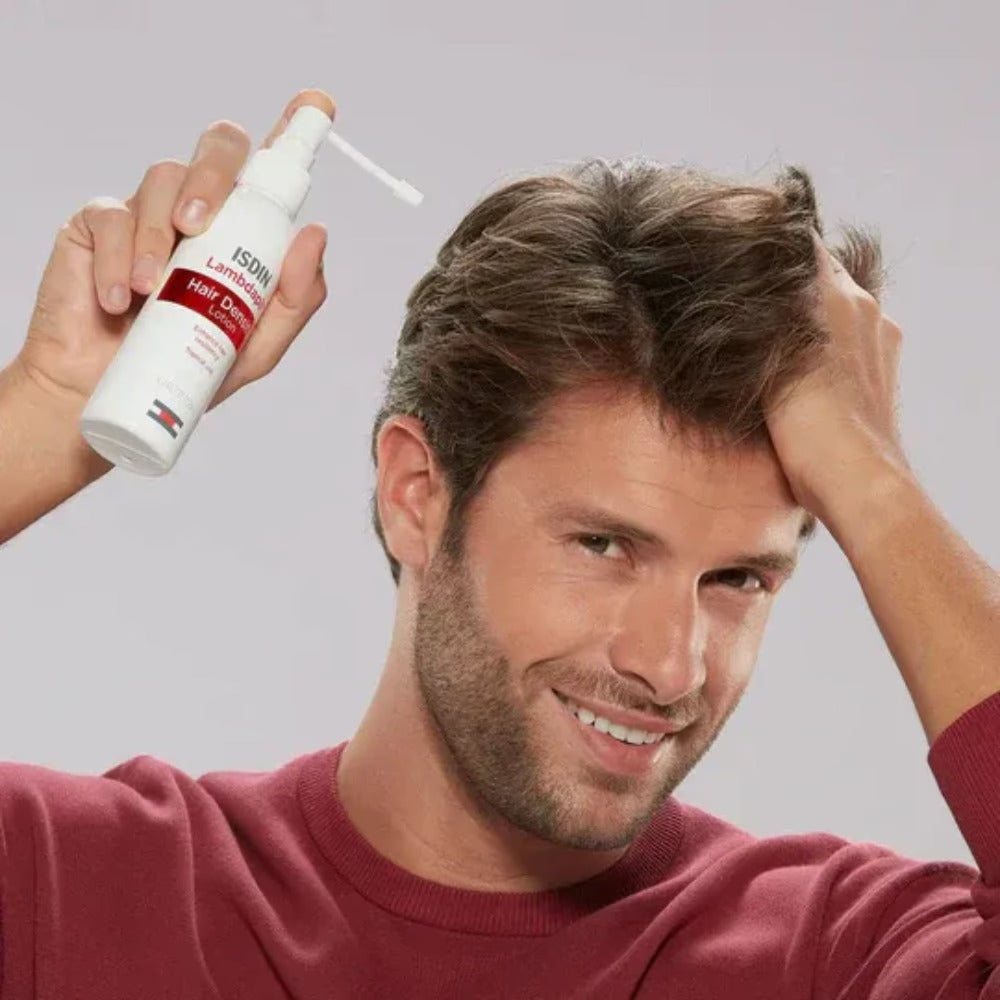 Man applying ISDIN Lambdapil Anti-Hairloss lotion spray on scalp for hair loss treatment
