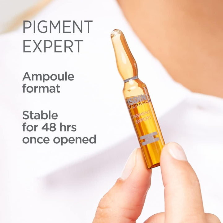 ISDIN Isdinceutics Pigment Expert serum ampoule held in hand for dark spot correction and skin brightening