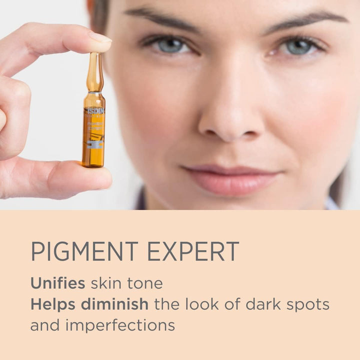 Close-up of a person holding ISDIN Isdinceutics Pigment Expert serum ampoule to brighten and unify skin tone, reducing dark spots and imperfections
