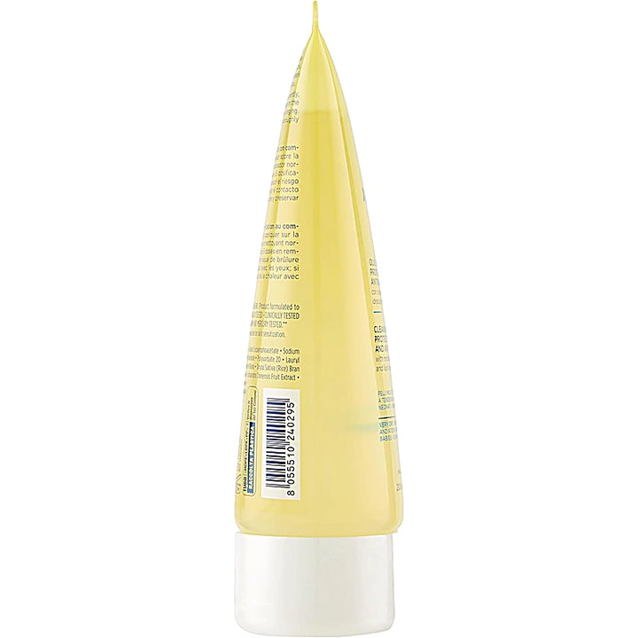 Back view of a yellow and white cosmetic bottle with text and a barcode on a white background