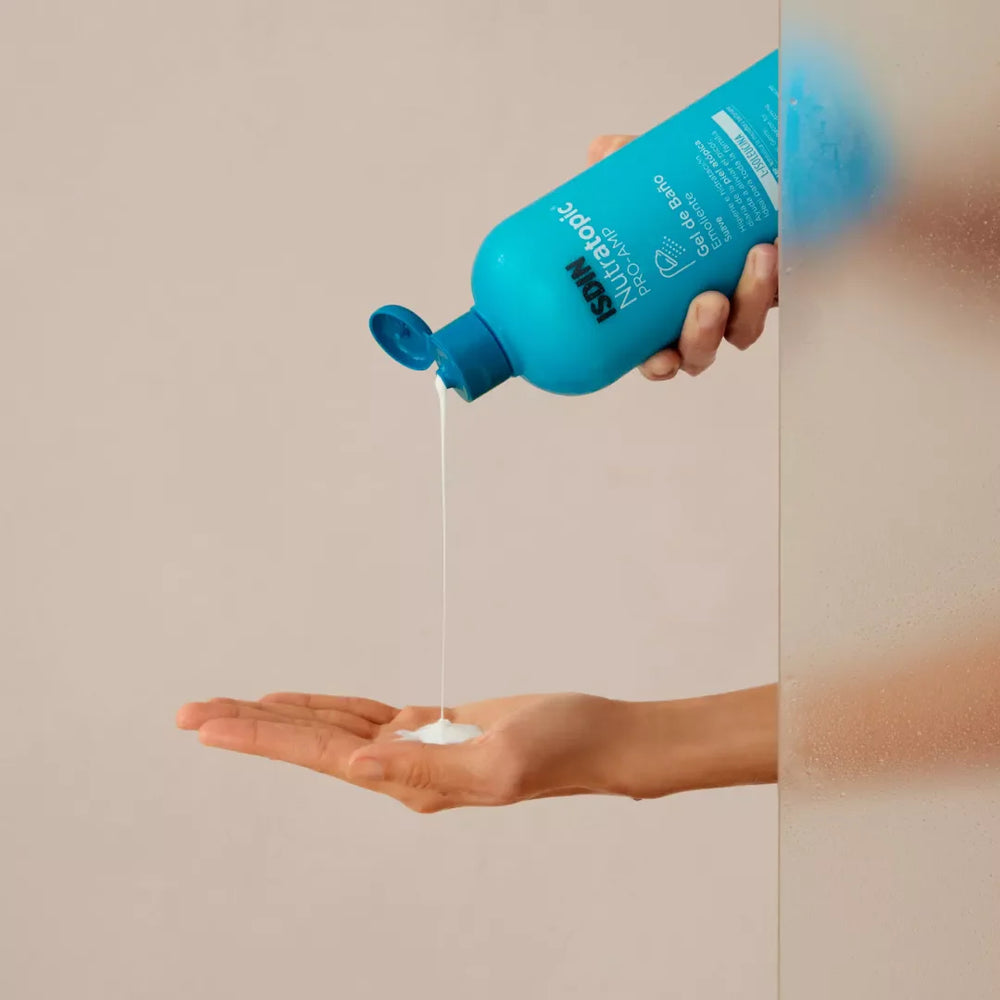 ISDIN Nutratopic Pro-Amp Emollient Bath Gel being poured into hand for atopic skin care