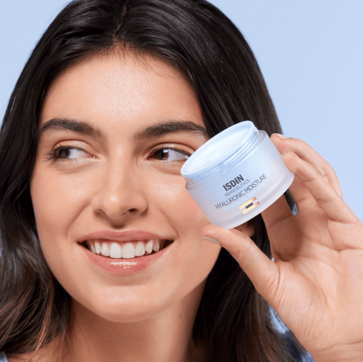 Woman holding ISDIN Isdinceutics Hyaluronic Moisture Cream for normal to dry skin, anti-aging moisturizer with hyaluronic acid and antioxidants