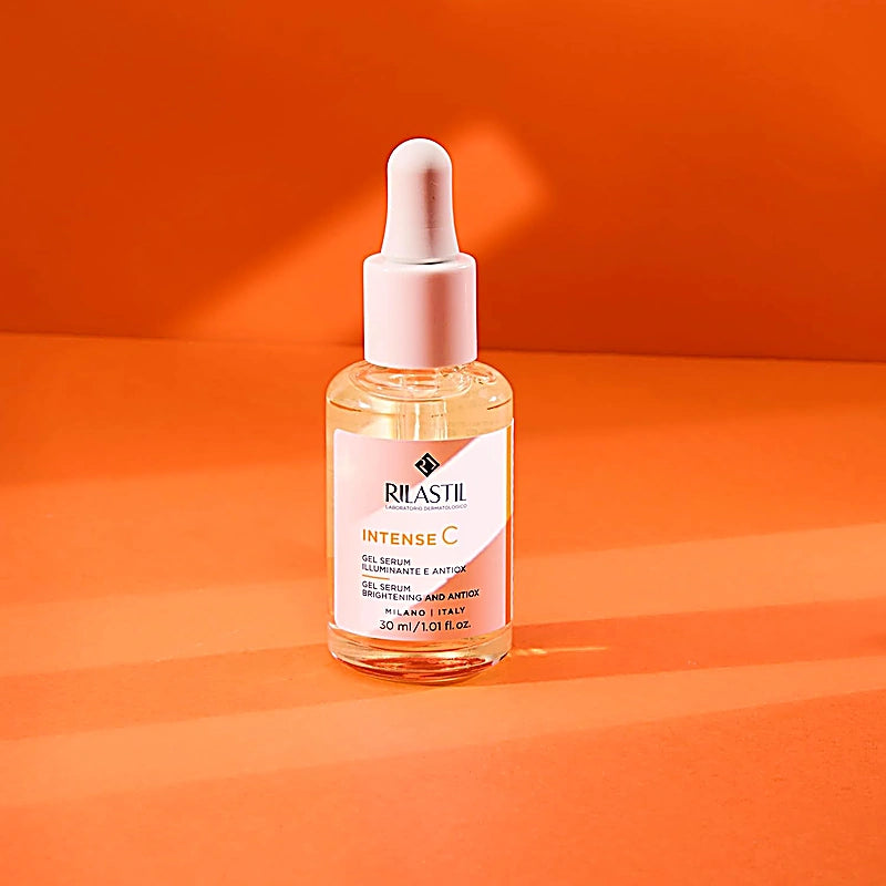 Rilastil Intense C skincare serum bottle on an orange background