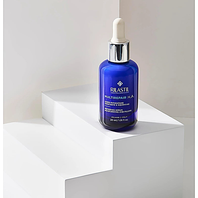 Rilastil skincare serum bottle on a white pedestal with a neutral background