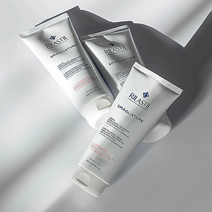 Three Rilastil Smagliature skincare products on a light gray background