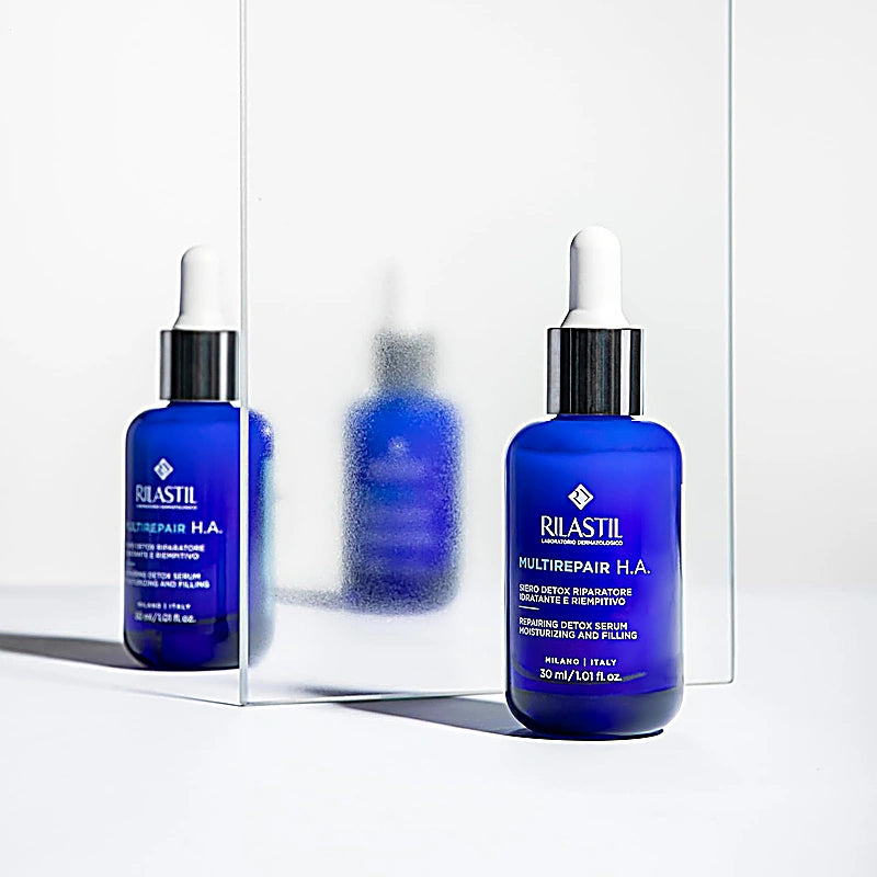 Two bottles of Rilastil Multirepair H.A. serum on a white background